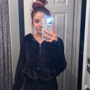 Black pullover with half zip up.